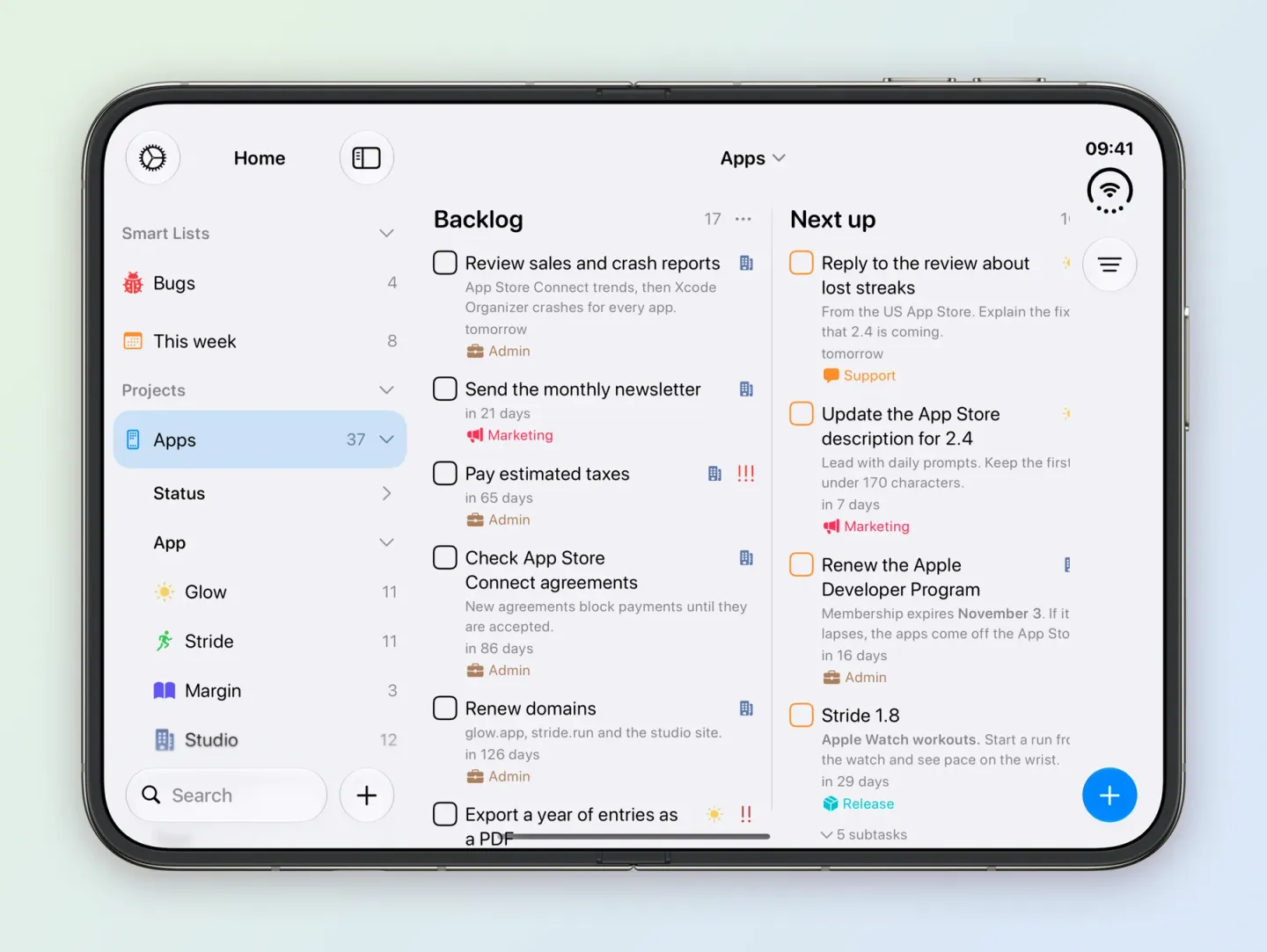 Tasks on an unfolded iPhone Duo. The Home sidebar lists the Bugs and This week Smart Lists and the Apps project, selected, with 37 tasks, expanded to Status and App with Glow 11, Stride 11, Margin 3 and Studio 12. The Apps board shows Backlog with 17 tasks, starting with Review sales and crash reports tomorrow, Send the monthly newsletter in 21 days, Pay estimated taxes in 65 days, Check App Store Connect agreements and Renew domains, and Next up with Reply to the review about lost streaks, Update the App Store description for 2.4, Renew the Apple Developer Program in 16 days and Stride 1.8 with 5 subtasks, each with its notes and tag.