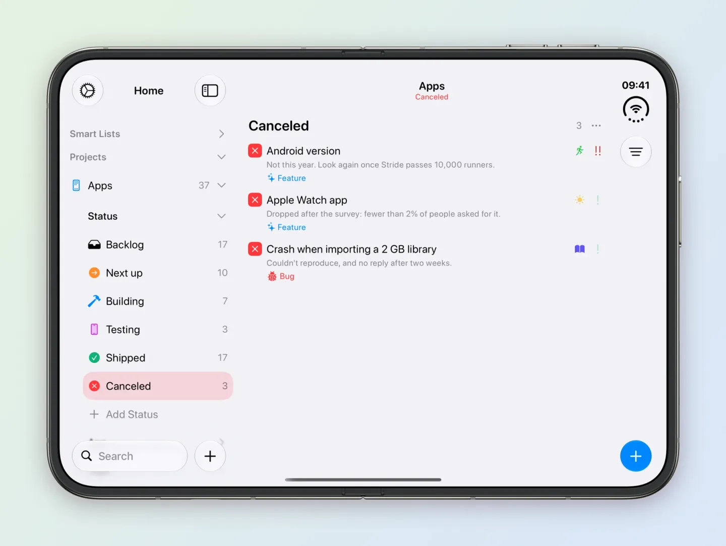 Tasks on an unfolded iPhone Duo with Apps expanded to Status in the sidebar, listing Backlog 17, Next up 10, Building 7, Testing 3, Shipped 17 and Canceled 3, with Canceled selected. The board, titled Apps and Canceled, shows three tasks with red crosses: Android version, noted Not this year, Apple Watch app, noted Dropped after the survey, and Crash when importing a 2 GB library, noted Couldn't reproduce.