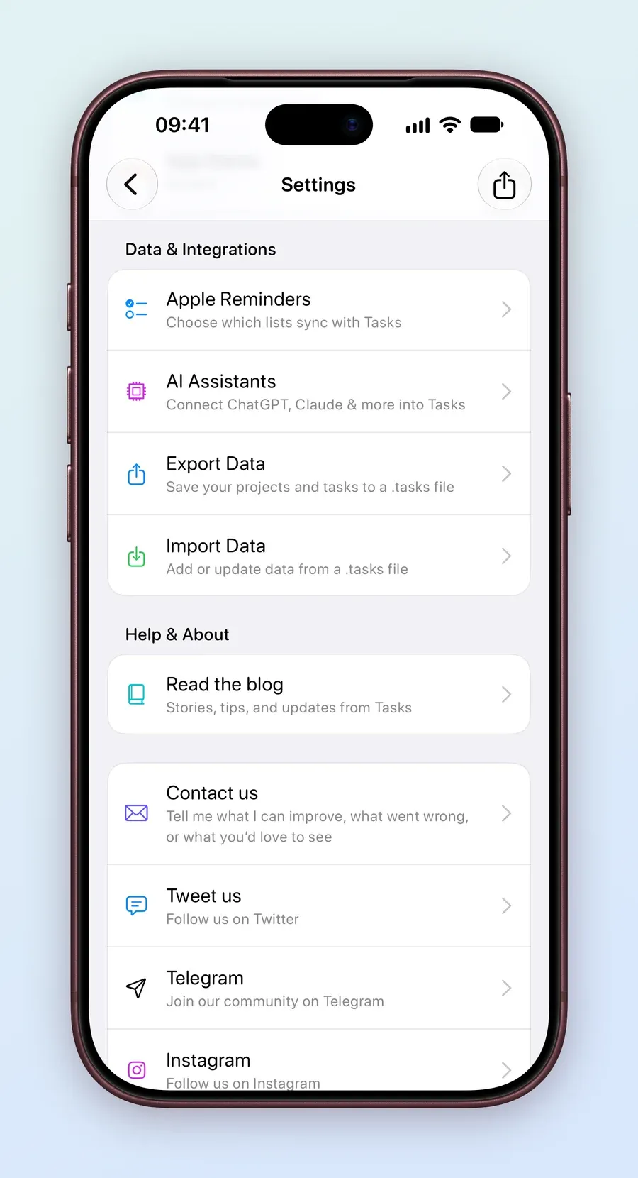 An iPhone screen of Tasks Settings showing Data and Integrations with Apple Reminders, AI Assistants, Export Data and Import Data, then Help and About with Read the blog, Contact us (Tell me what I can improve, what went wrong, or what you'd love to see), Tweet us, Telegram and Instagram.